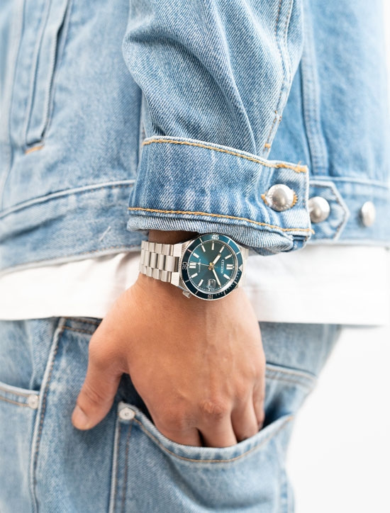 Mann in Jeansjacke mit Uhr am Handgelenk
