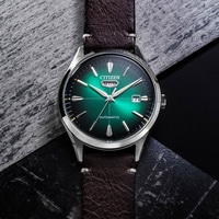Eine grüne Citizen Automatik-Uhr auf dunklem, texturiertem Hintergrund.