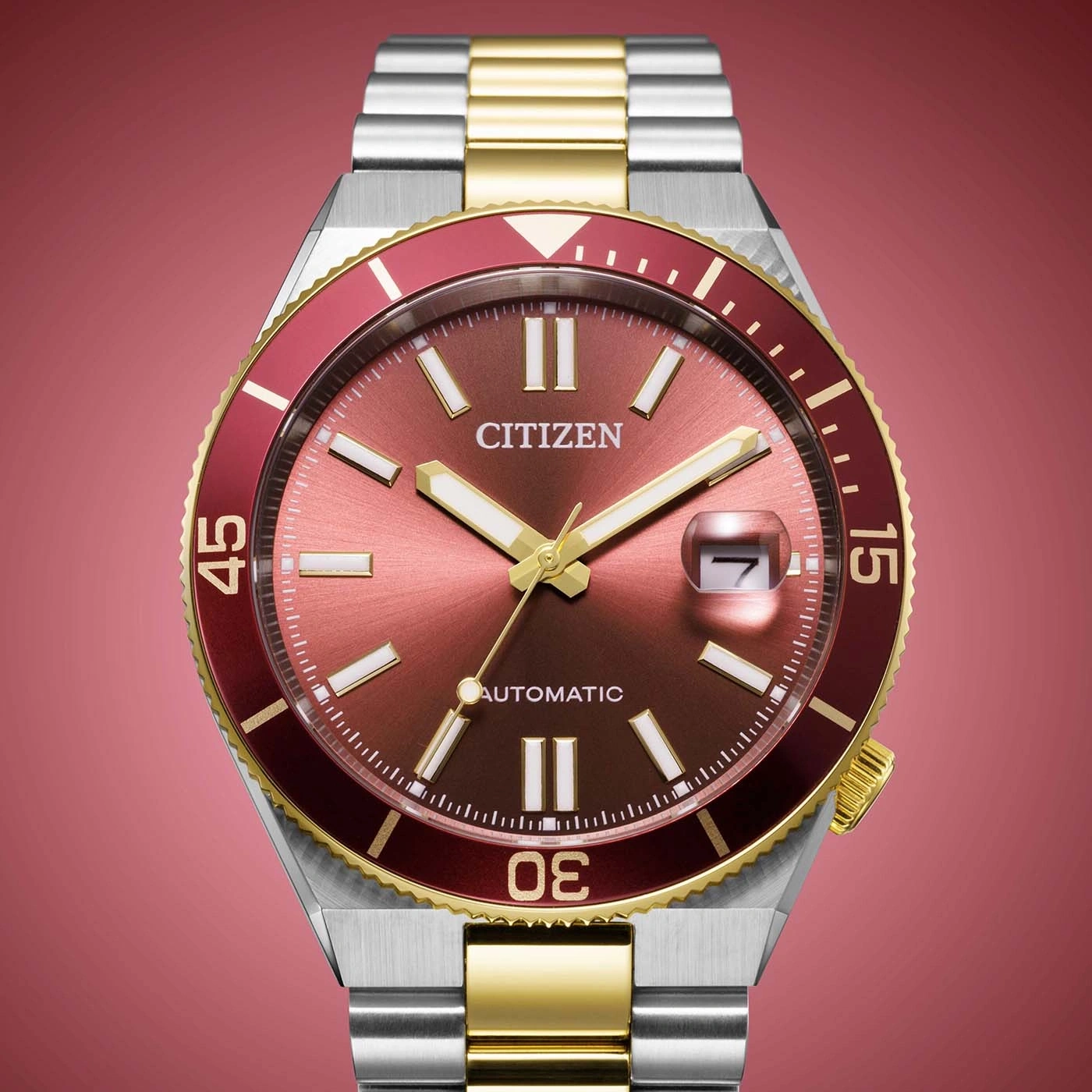 Eine Citizen Taucheruhr mit rotem Zifferblatt und passender Lünette, zweifarbiges Armband.