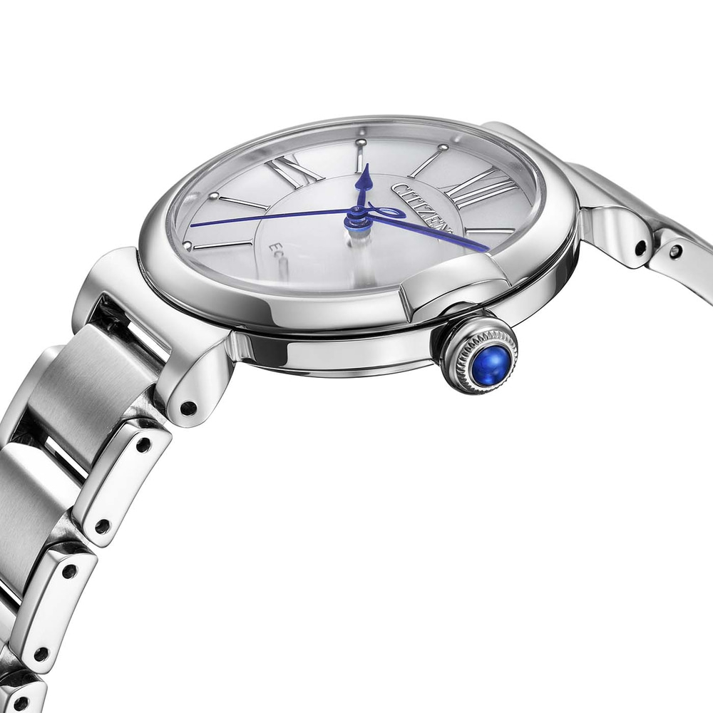 Gros plan d'une montre Citizen Eco-Drive argentée avec des aiguilles bleues et une gemme bleue sur la couronne.