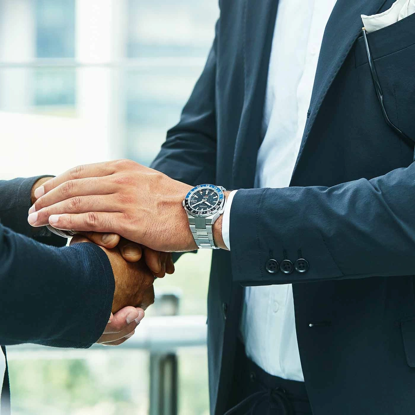 Business handshake with a watch on the wrist, a symbol of agreement.