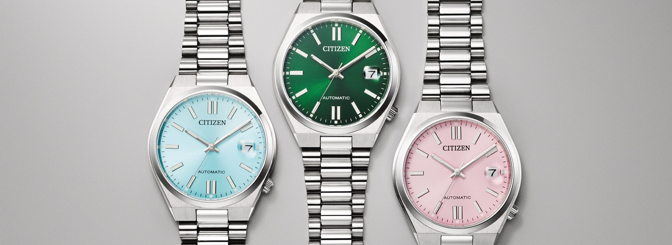 Drei Citizen Uhren mit hellblauen, grünen und rosa Zifferblättern.