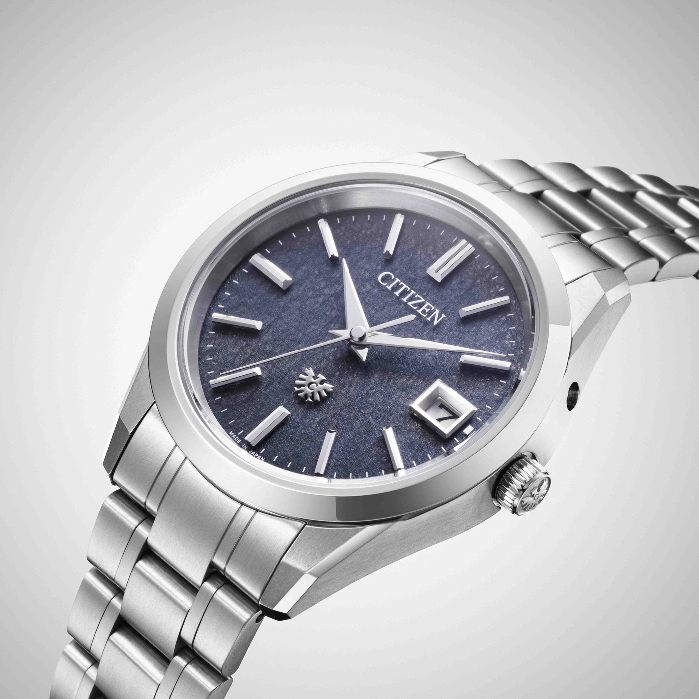 Eine silberne Citizen-Uhr mit blauem Zifferblatt und Metallarmband.